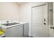 Bright laundry room featuring a modern Samsung washer and dryer set and a white paneled door at 2925 Sw 172Nd Lane Rd, Ocala, FL 34473