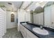 Well-lit bathroom featuring tiled floors, decorative wallpaper and double sink vanity at 3030 Kingfisher Dr, Orlando, FL 32806