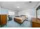 Cozy bedroom featuring a classic wood bed frame and calming blue walls at 3030 Kingfisher Dr, Orlando, FL 32806