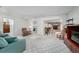 Inviting living room with white walls, plush carpet and seamless flow to adjacent spaces at 3030 Kingfisher Dr, Orlando, FL 32806