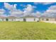 Large backyard offers ample space with healthy green grass, complemented by neighboring homes at 304 Towns Cir, Haines City, FL 33844