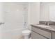 Bright bathroom with a shower-tub combo and vanity featuring a stone countertop at 304 Towns Cir, Haines City, FL 33844