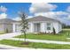 Beautiful single-story home featuring a well-maintained lawn and garden, complemented by a two-car garage at 304 Towns Cir, Haines City, FL 33844