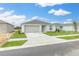 Inviting single-story home with a well-kept lawn, complemented by a two-car garage and neutral palette at 304 Towns Cir, Haines City, FL 33844