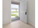 Inviting foyer with tile flooring, offering a glimpse of the home's exterior and front yard at 304 Towns Cir, Haines City, FL 33844