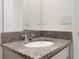 Bathroom vanity featuring a stone countertop, white sink, and chrome faucet at 304 Towns Cir, Haines City, FL 33844