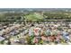 Aerial view featuring a residential area near a golf course with well-kept lawns and landscaping at 3175 Arrowhead Ln, Kissimmee, FL 34746