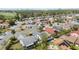 Neighborhood aerial view featuring a single-Gathering home near a golf course and a tree-lined neighborhood at 3175 Arrowhead Ln, Kissimmee, FL 34746