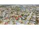 Aerial view featuring a neighborhood with tree-lined streets near a lake and recreational area at 3175 Arrowhead Ln, Kissimmee, FL 34746