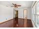 Bedroom featuring hardwood floors, ceiling fan, and a walk-in closet at 3175 Arrowhead Ln, Kissimmee, FL 34746