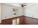 Bedroom with hardwood floors, ceiling fan and window overlooking the backyard at 3175 Arrowhead Ln, Kissimmee, FL 34746