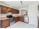 Updated kitchen featuring stainless steel appliances, granite countertops, and dark wood cabinets at 3175 Arrowhead Ln, Kissimmee, FL 34746