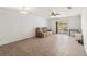 Relaxing living room with tile flooring, ceiling fan, and sliding glass door to backyard at 3175 Arrowhead Ln, Kissimmee, FL 34746