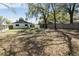 Large backyard with privacy fence and mature trees offers ample space for outdoor activities and relaxation at 3455 Jujube Dr, Orlando, FL 32810