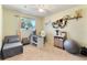 Cozy bedroom with natural light, a ceiling fan and neutral carpet is staged as a home office at 3455 Jujube Dr, Orlando, FL 32810