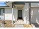 Welcoming front porch featuring neutral tile flooring, a stylish entry door, and classic architectural columns at 3455 Jujube Dr, Orlando, FL 32810