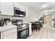 Modern kitchen with stainless steel appliances and reflective wall panel for an illusion of added space at 3455 Jujube Dr, Orlando, FL 32810