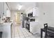 Well-lit kitchen with white cabinets, stainless steel appliances, and tiled floor at 3455 Jujube Dr, Orlando, FL 32810