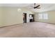 Spacious living room boasts a cozy fireplace, ample natural light, and a ceiling fan at 3455 Jujube Dr, Orlando, FL 32810