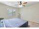 Comfortable main bedroom featuring a ceiling fan and a window offering plenty of natural light at 3455 Jujube Dr, Orlando, FL 32810