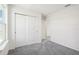 Bedroom featuring sliding door closet, neutral carpet, and bright natural light at 3483 Salvia Ct, Tavares, FL 32778