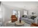 Cozy living room with neutral tones, a comfortable sofa, and ample natural light from sliding glass doors at 3483 Salvia Ct, Tavares, FL 32778