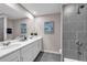 Modern bathroom showcasing gray tiling, dual vanity with white countertop, and sleek, contemporary fixtures at 3489 Salvia Ct, Tavares, FL 32778