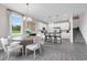 Bright dining room features a modern chandelier and open floor plan to the kitchen at 3489 Salvia Ct, Tavares, FL 32778