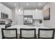 Modern kitchen featuring white cabinets, an island with seating, and stainless steel appliances at 3489 Salvia Ct, Tavares, FL 32778