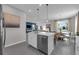Modern kitchen featuring stainless steel appliances, an island with seating, and open concept design at 3489 Salvia Ct, Tavares, FL 32778