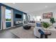 Comfortable living room features a blue accent wall, modern decor, and large windows at 3489 Salvia Ct, Tavares, FL 32778