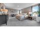 Spacious main bedroom featuring carpet, large windows, and a decorative accent wall at 3489 Salvia Ct, Tavares, FL 32778