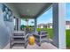 Cozy covered patio featuring comfortable outdoor seating with a view of the beautifully landscaped backyard at 3489 Salvia Ct, Tavares, FL 32778