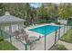 A gated pool features ample seating and community information about pool rules and hours of operation at 35 Misners Trl, Ormond Beach, FL 32174