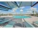 Large community pool area with blue skies and covered lounge seating at 3590 Dahlia Dr, Haines City, FL 33844