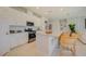 Well-lit kitchen featuring white cabinetry, granite countertops, stainless appliances, and a large island at 3590 Dahlia Dr, Haines City, FL 33844