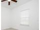 Bright bedroom featuring a ceiling fan, a large window with blinds, and neutral color palette at 3892 Sw 130Th Loop, Ocala, FL 34473