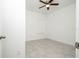 Bright bedroom with a ceiling fan and neutral gray tile flooring at 3892 Sw 130Th Loop, Ocala, FL 34473