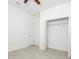 Bedroom featuring an open closet with a wire shelf and neutral gray tile flooring at 3892 Sw 130Th Loop, Ocala, FL 34473