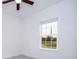 Bright bedroom featuring a ceiling fan, a large window, and neutral color palette at 3892 Sw 130Th Loop, Ocala, FL 34473