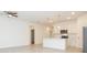 Bright, white kitchen featuring a central island with pendant lighting and stainless steel appliances at 3892 Sw 130Th Loop, Ocala, FL 34473