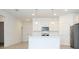 Bright, white kitchen featuring a central island with pendant lighting and stainless steel appliances at 3892 Sw 130Th Loop, Ocala, FL 34473