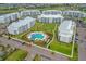 Overhead photo featuring modern apartments around a pool with palm trees, close to lush green spaces at 4865 Clock Tower Dr, Kissimmee, FL 34746