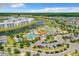 A vibrant aerial of community amenities by a lake, with lush landscaping and ample parking at 4865 Clock Tower Dr, Kissimmee, FL 34746