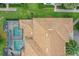 Bird's-eye view highlighting a pool with screened enclosures and colorful roof tiles in a residential area at 4865 Clock Tower Dr, Kissimmee, FL 34746