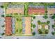 Overhead angle of charming townhomes with individual pools, set within a green landscape and paved streets at 4865 Clock Tower Dr, Kissimmee, FL 34746