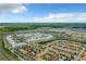 Captivating aerial image of townhomes and apartments surrounding a serene lake and lush greenery at 4865 Clock Tower Dr, Kissimmee, FL 34746