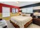 Bright bedroom with horizontally striped accent wall and modern lamps on nightstands at 4865 Clock Tower Dr, Kissimmee, FL 34746