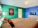 Well-lit bedroom with dual-color walls, and a comfortable bed, creating a cozy and inviting space at 4865 Clock Tower Dr, Kissimmee, FL 34746