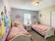 Bedroom featuring twin beds with crown decor and princess wall art at 4865 Clock Tower Dr, Kissimmee, FL 34746